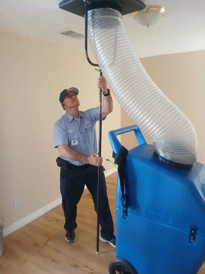Furnace Tune-Up technician using HEPA equipment in Dade City